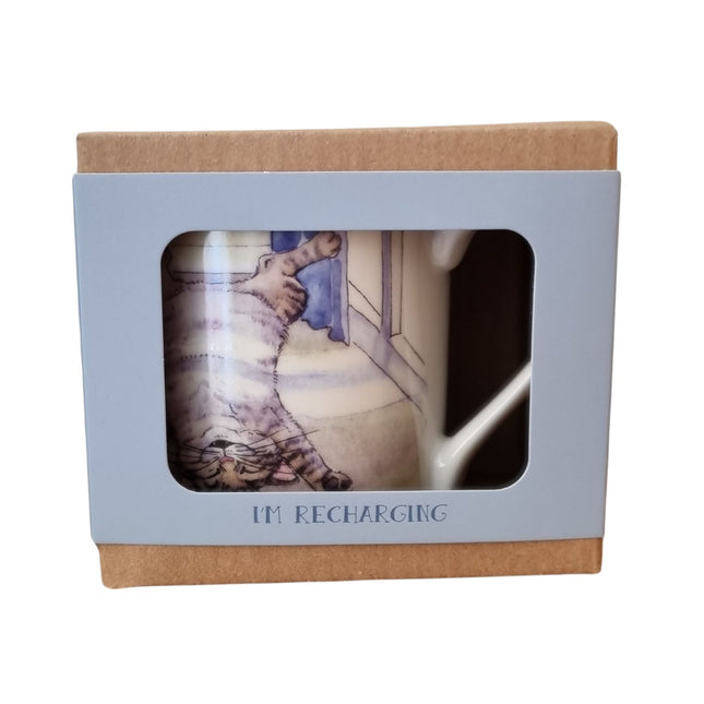 The Alisons Animals Cat Mug features a playful Re-charging cartoon of a cat on its back, packaged in a light brown and blue gift box with “IM RECHARGING” below the window—perfect for cat lovers.