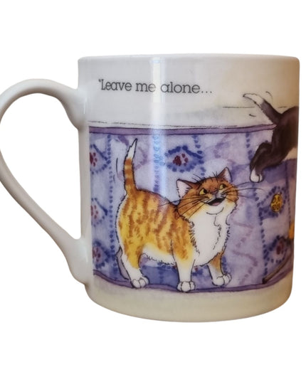 The Alisons Animals Cat Mug features a cartoon of a smiling orange and white cat on a rug with “Leave me alone...” above. This white porcelain mug comes gift boxed and is part of the Alisons Animals Re-charging range.