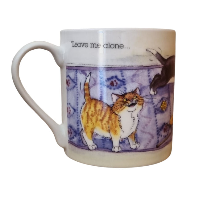 The Alisons Animals Cat Mug features a cartoon of a smiling orange and white cat on a rug with “Leave me alone...” above. This white porcelain mug comes gift boxed and is part of the Alisons Animals Re-charging range.