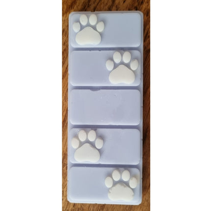 the top view of a light blue wax melt bar with white paw prints