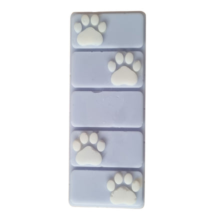 the top view of a light blue wax melt bar with white paw prints