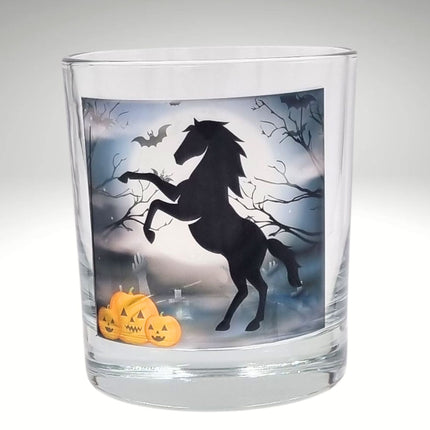 halloween candle glass tealight holder with a black rearing horse and pumpkins in a graveyard setting
