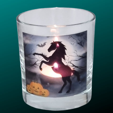 halloween candle glass tealight holder with a black rearing horse and pumpkins in a graveyard setting