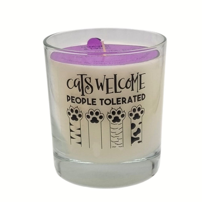 The Quaver&Lyric Funny Cat Lover Gift Scented Glass Container Candle (30cl) features a purple top and the words CATS WELCOME PEOPLE TOLERATED above four illustrated cat paws.