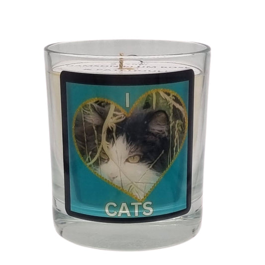 scented candle in glass container with fluffy black and white cat in a heart love cats design