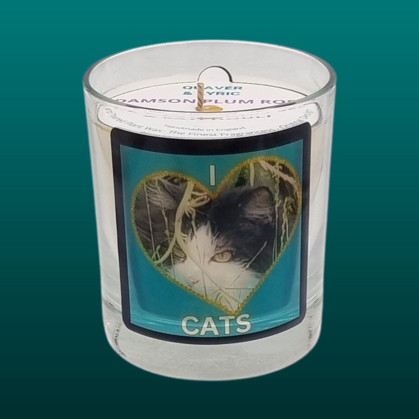 scented candle in glass container with fluffy black and white cat in a heart love cats design 