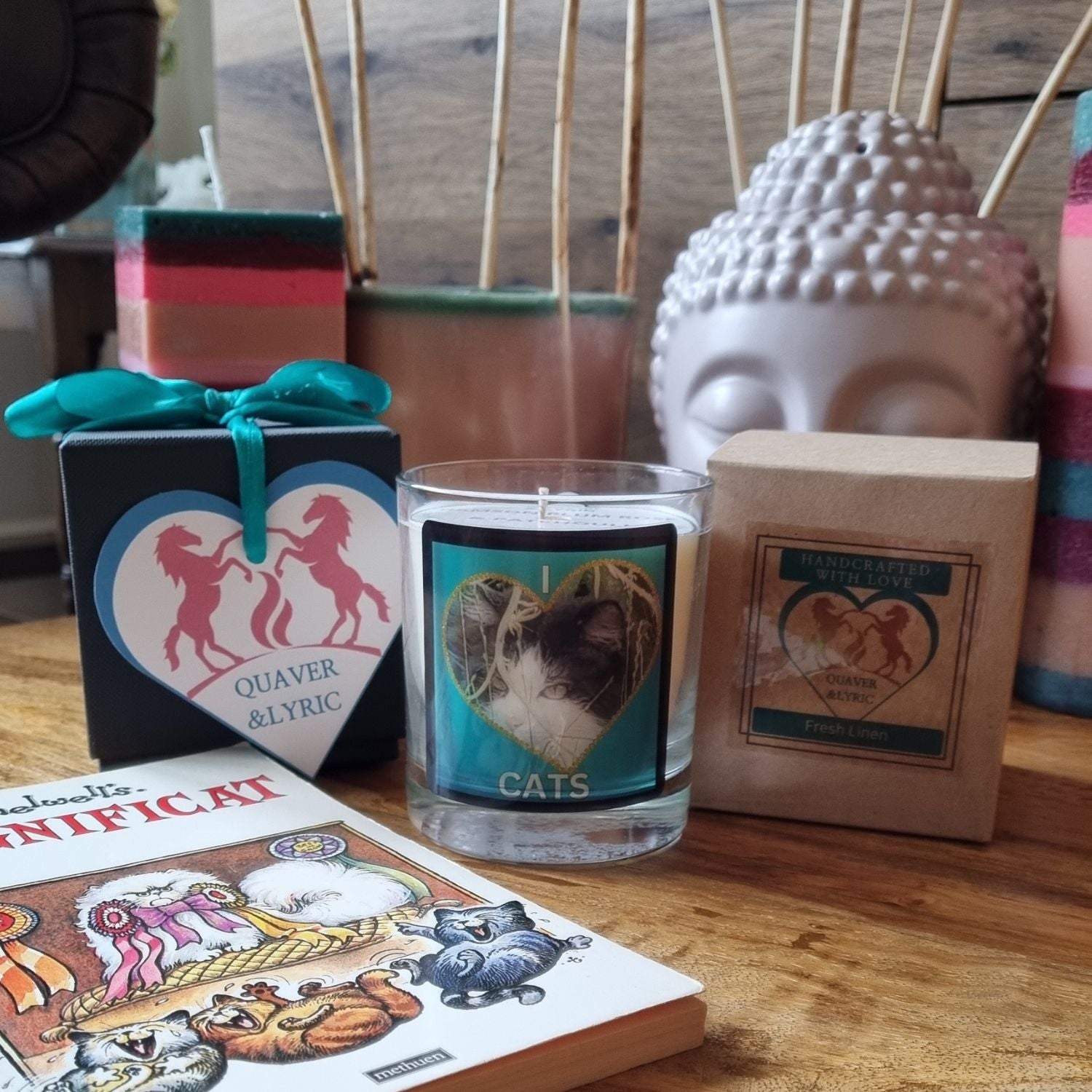 scented candle in glass container with fluffy black and white cat in a heart love cats design on a table with the packaging and gift box