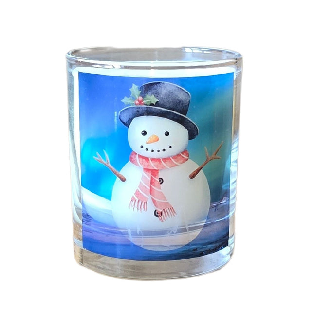 The Quaver&Lyric Christmas Scented Candle comes in a glass container featuring a cheerful snowman design, making it the perfect festive decor and gift for your holiday celebrations.