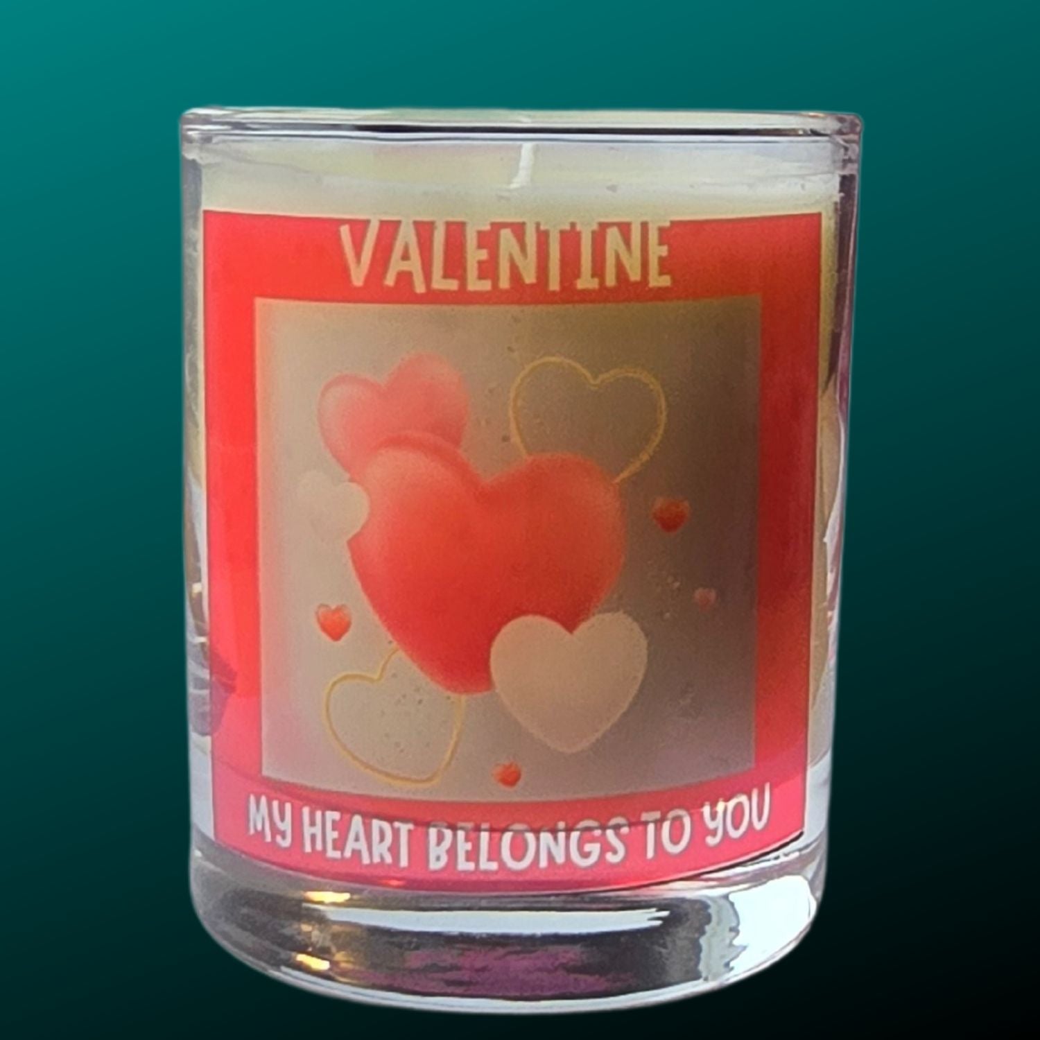 a valentine candle in a glass container with red heart design