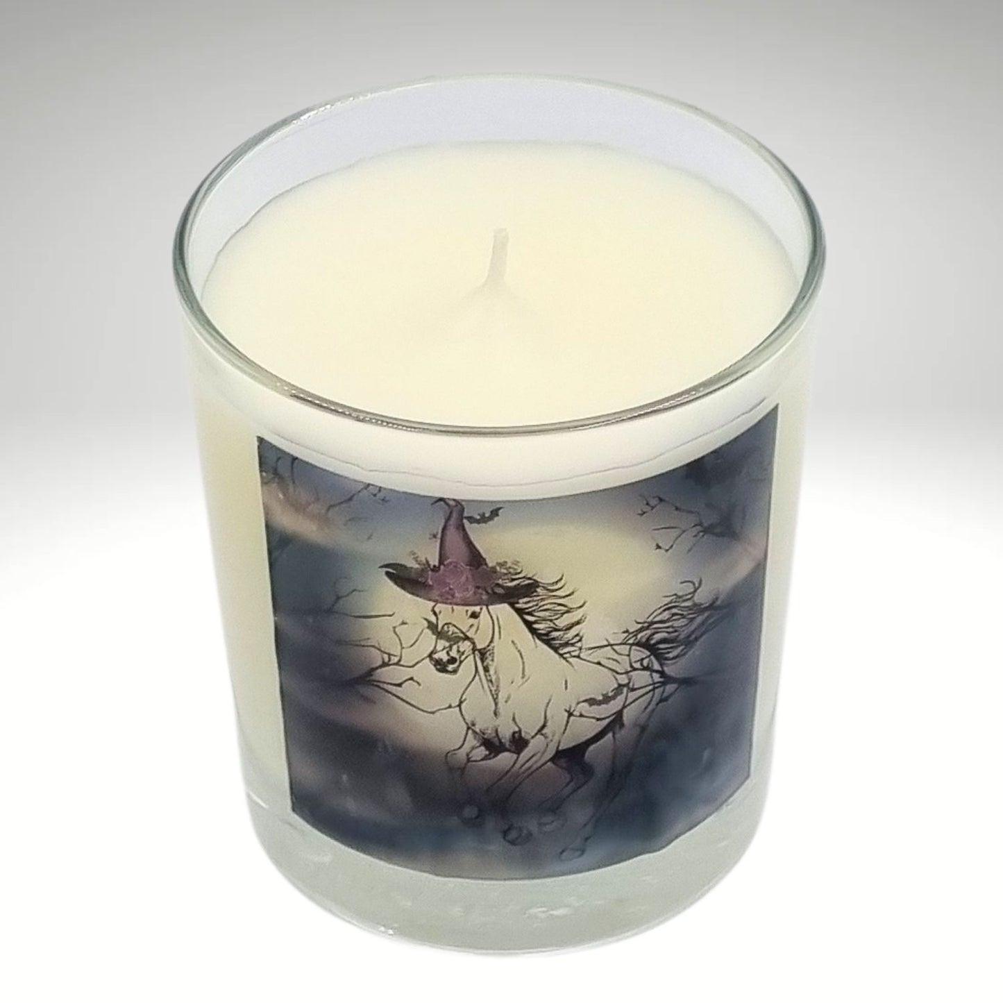 a scented halloween candle featuring a spooky galloping horse design