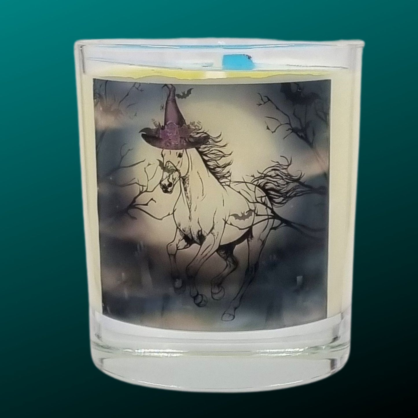 a scented halloween candle featuring a spooky galloping horse design