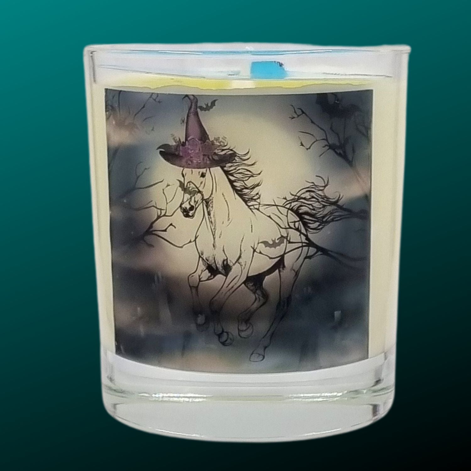 a scented halloween candle featuring a spooky galloping horse design