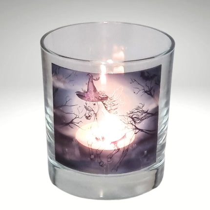 a lit halloween tealight candle holder featuring a spooky galloping horse design