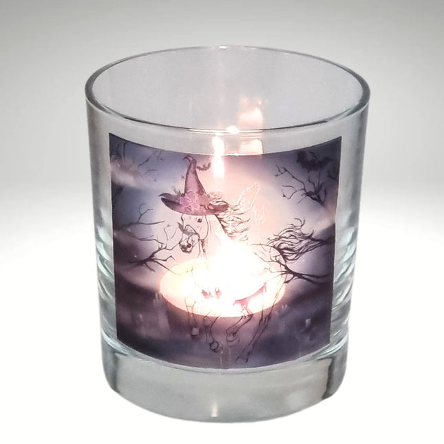 a lit halloween tealight candle holder featuring a spooky galloping horse design