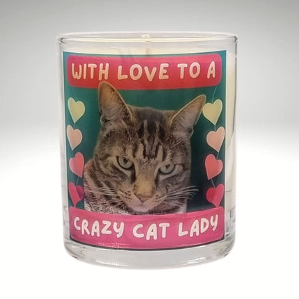 The Quaver&Lyric Scented Candle In Glass Container features a Bengal cat, colorful hearts, and â€œWith love to a crazy cat ladyâ€ on pink and redâ€”infused with premium fragrance, perfect for gifting!.