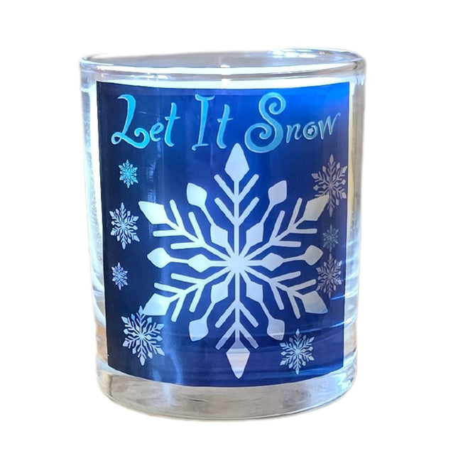 The Quaver&Lyric Christmas Scented Candle comes in a clear glass container with a blue Let It Snow label adorned with white snowflakes—perfect as festive home decor or a thoughtful holiday gift.