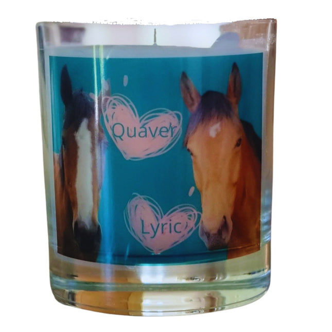 The Quaver&Lyric Scented Candle in Glass features a blue label with two horsesâ€”Quaver and Lyricâ€”in heart designs. Handmade and filled with premium fragrances, it adds an enchanting touch to your space.