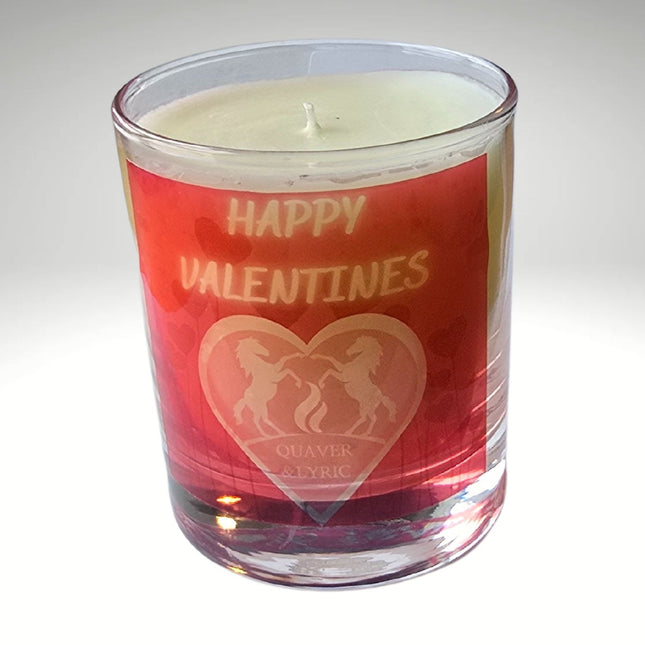 The Quaver&Lyric Scented Happy Valentine Candle (30cl) comes in a glass container with a red label featuring two unicorns and â€œQuaver & Lyric.â€ Handmade in Barton Seagrave, it reads â€œHappy Valentinesâ€ and offers premium fragrances.
