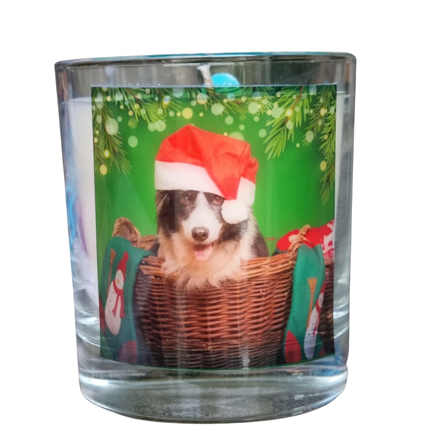 a christmas scented candle in a glass container with a festive collie dog in a santa hat design