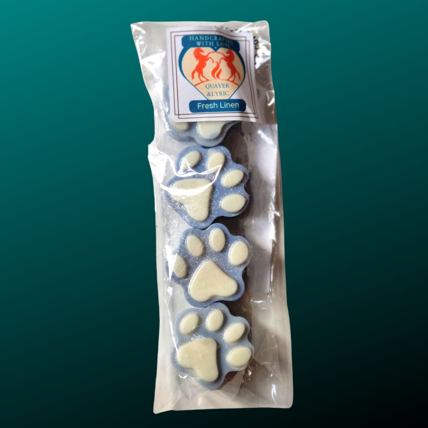 four dusky blue paw shaped wax melts with white paw pads in a packet with quaver & lyric rearing horse branding