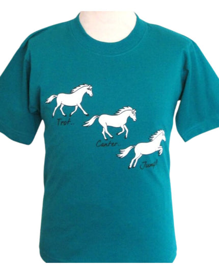 From British Country Collection, the Printed Horse T Shirt With Trot, Canter, Jump Design for children features a charming white horse in three playful posesâ€”Trot, Canter, and Jumpâ€”on a vibrant teal background.