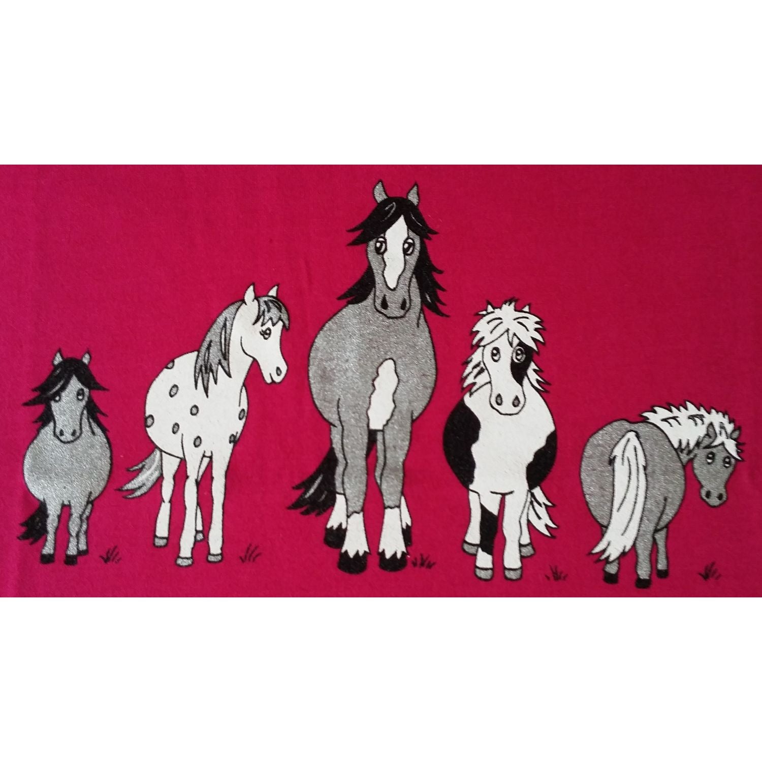 The British Country Collection Printed Horse T Shirt The Herd Design for children aged 1-2 features five unique cartoon horses in black, white, and gray on a bright pink backgroundâ€”made from soft 100% cotton.