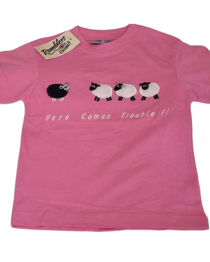 The Ramblers Embroidered T Shirt Sheep Kids “Here Comes Trouble” design features a pink premium cotton tee with playful black and white sheep embroidery and a Ramblers tag on the collar.