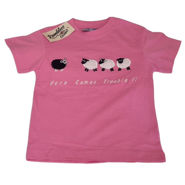 The Ramblers Embroidered T Shirt Sheep Kids “Here Comes Trouble” design features a pink premium cotton tee with playful black and white sheep embroidery and a Ramblers tag on the collar.