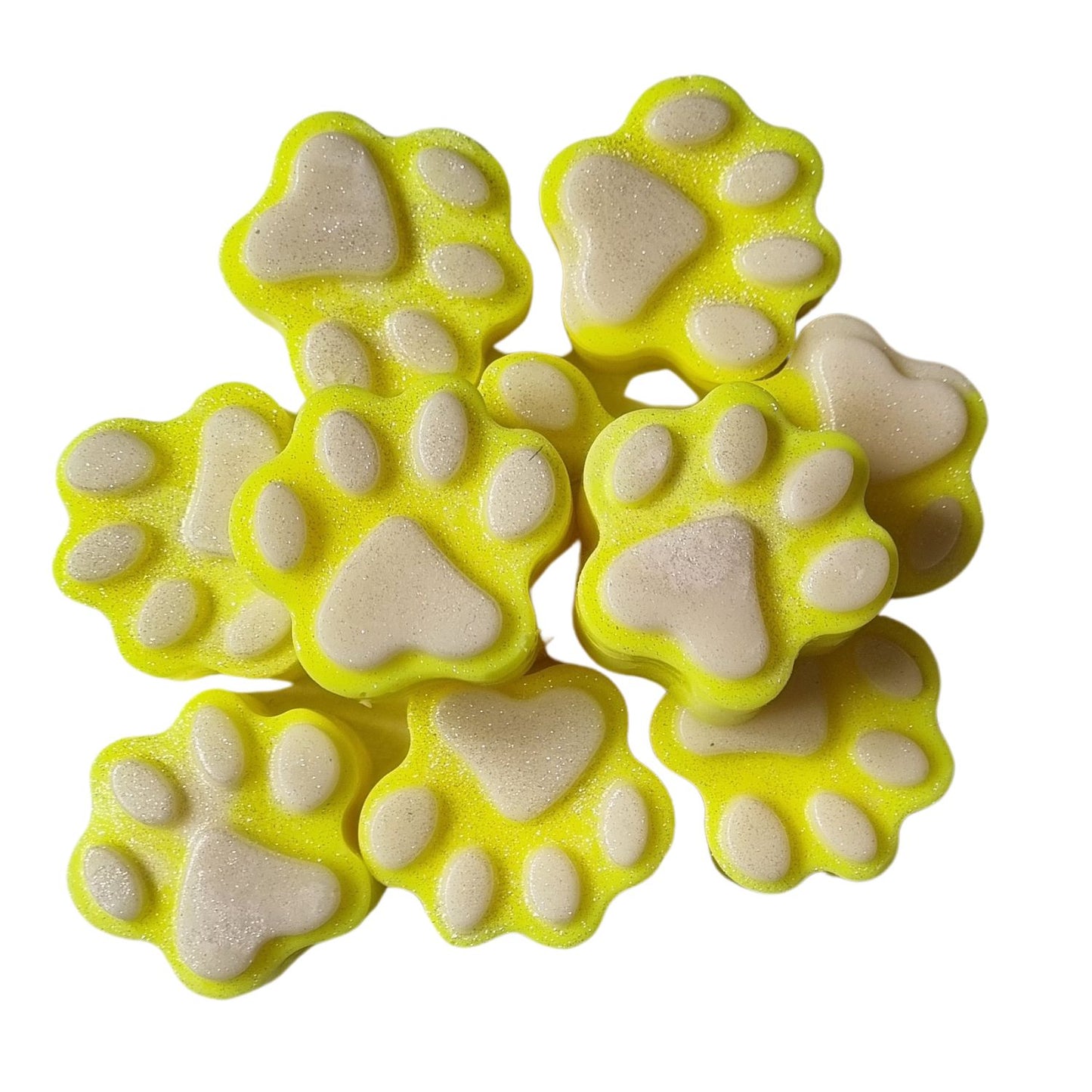 a group of yellow paw shaped wax melts with white paw pads