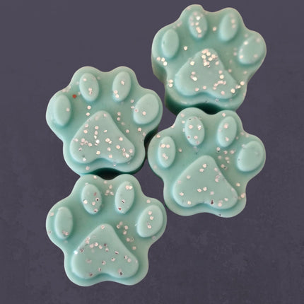 four paw shaped green wax melts with glitter