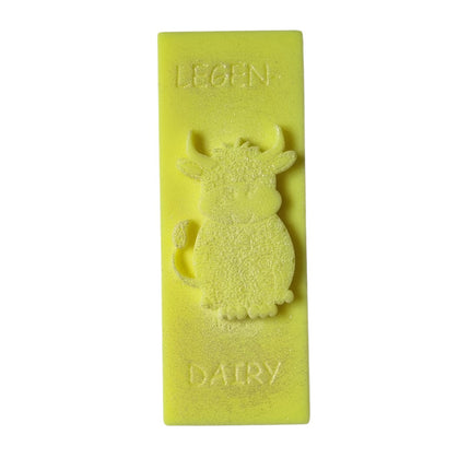 a bright yellow Wax Melt bar with highland cow and writing legen....dairy