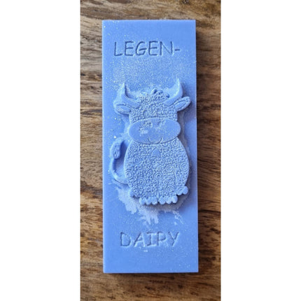 a blue Wax Melt bar with highland cow and writing legen....dairy