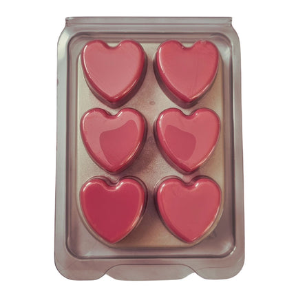 a wax melt bar in clamshell with 6 pink hearts