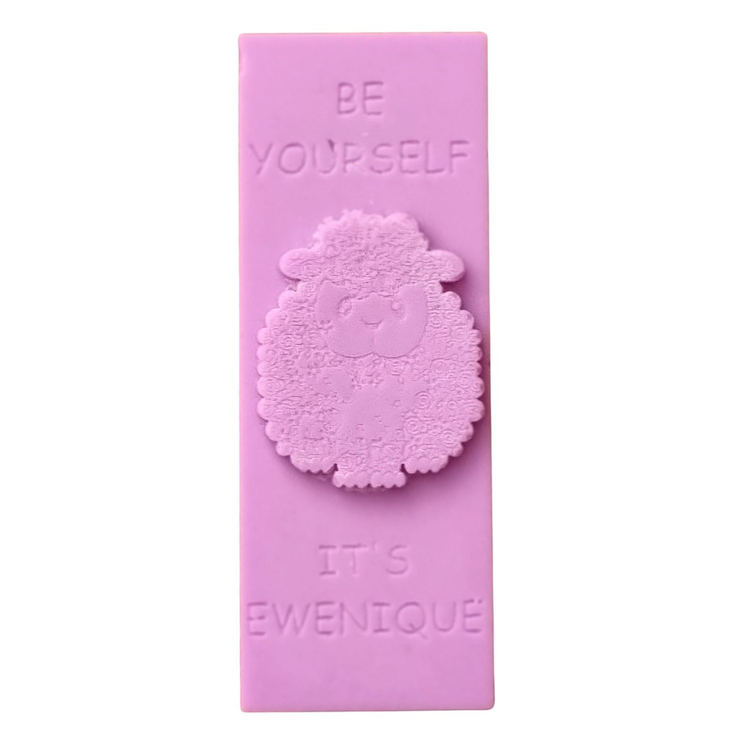 A pink coloured wax melt bar with a raised sheep design with the writing be yourself above and it's ewenique below.