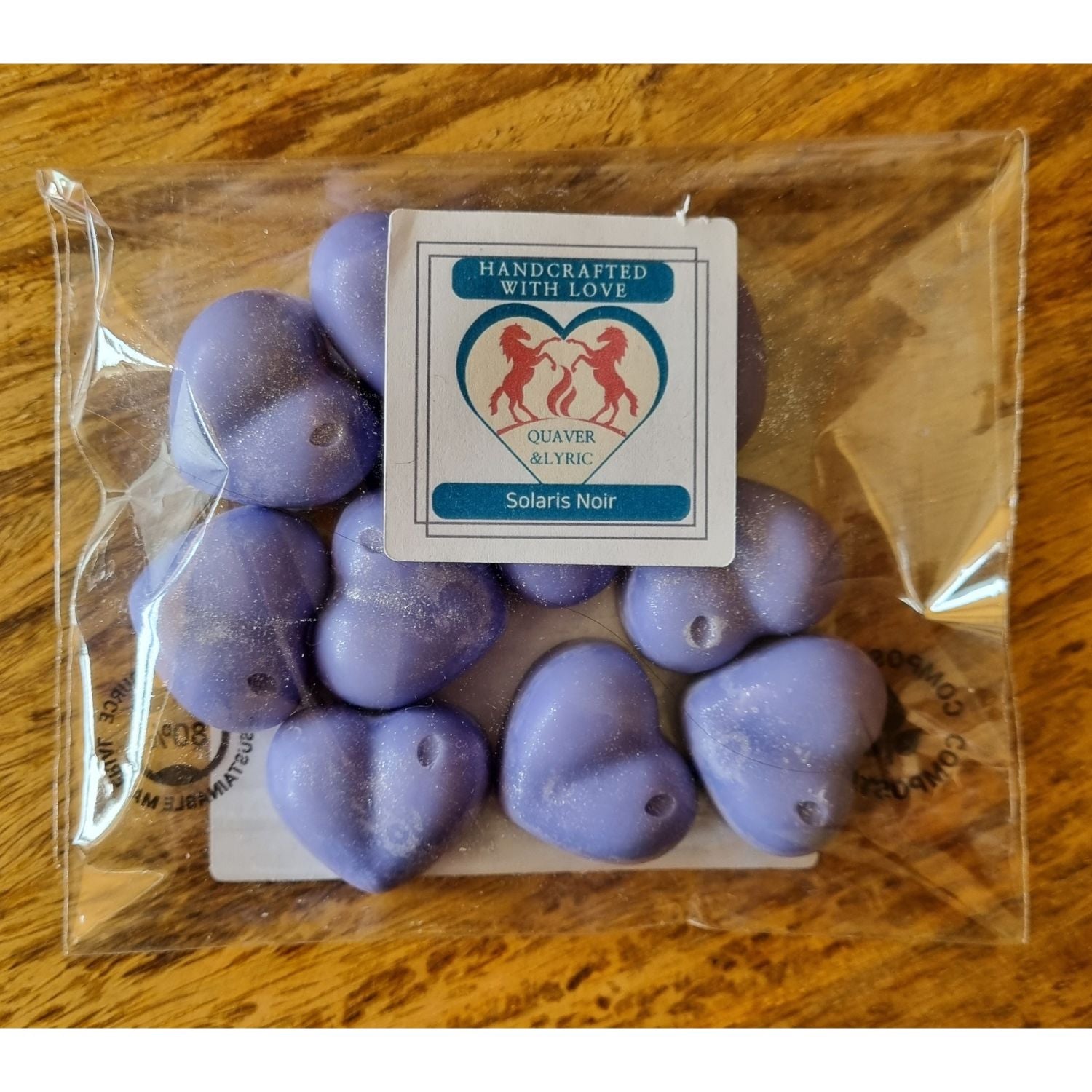 ten violet heart shaped soy wax melts in a packet with Quaver and Lyric branding