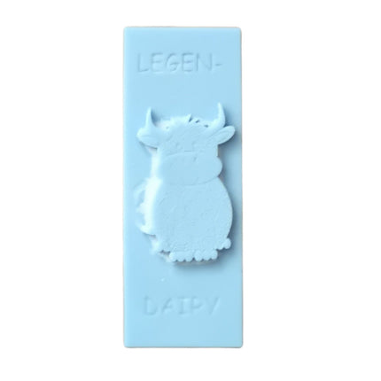 a light blue Wax Melt bar with highland cow and writing legen....dairy