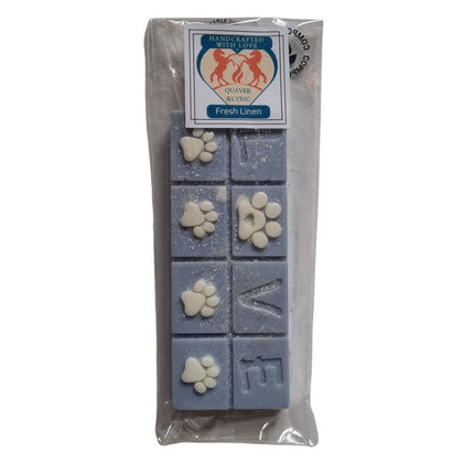 A packet with quaver and lyric branding containing a blue Scented Wax Melt bar with love and white paw prints 