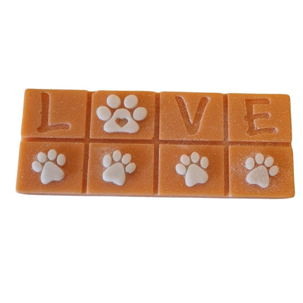 An orange Scented Wax Melt bar with love and white paw prints
