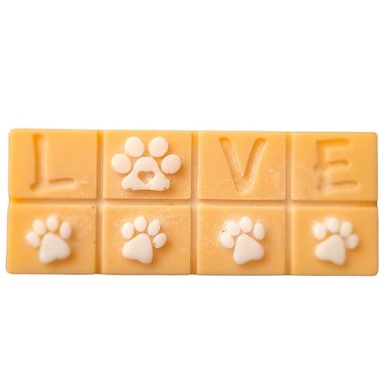 A light orange Scented Wax Melt bar with love and white paw prints