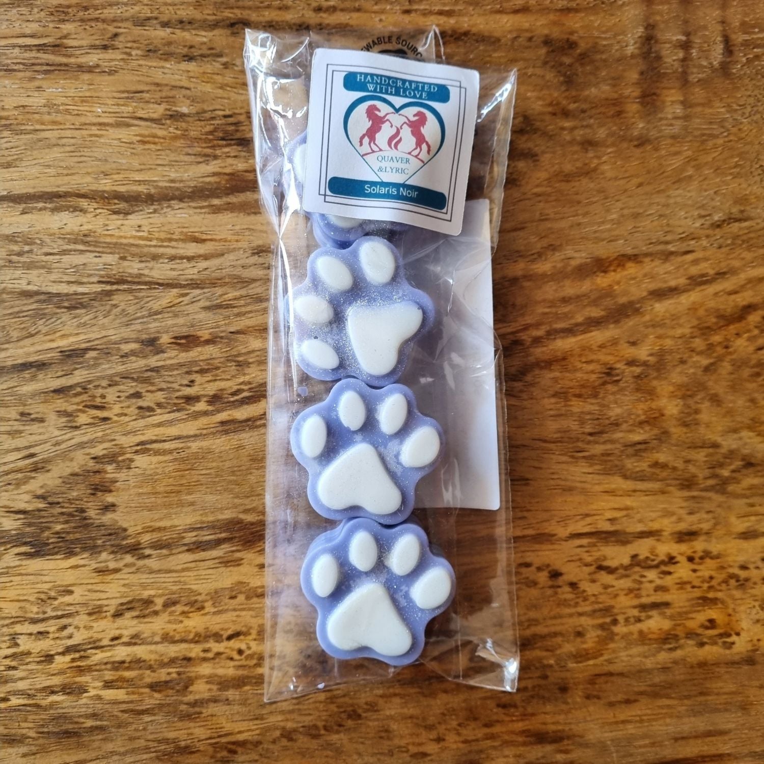 four mid blue paw shaped wax melts with white paw pads ina packet with quaver & lyric rearing horse branding