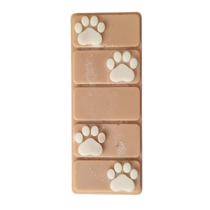 the top view of a brown wax melt bar with white paw prints