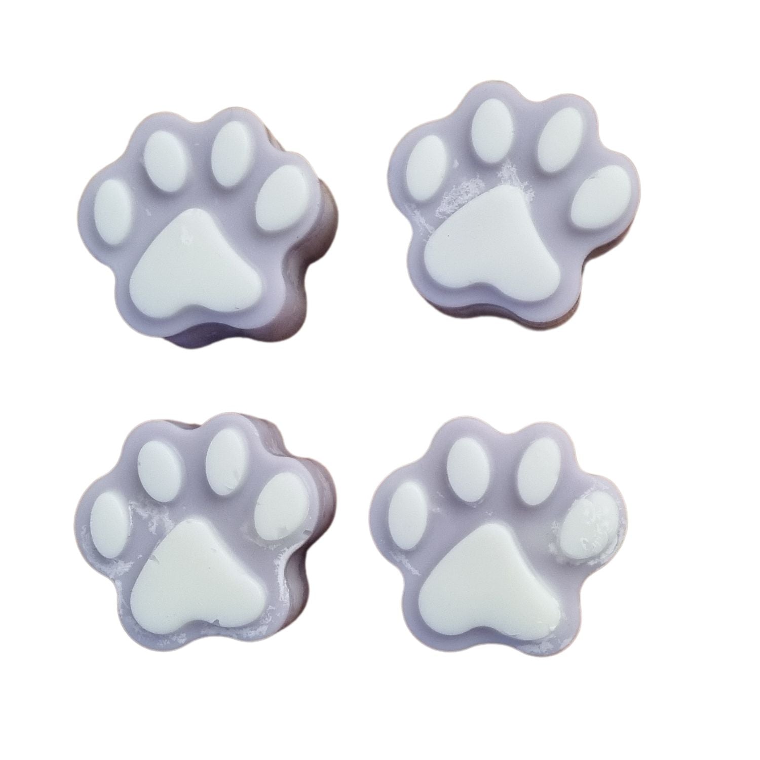 a group of four light blue paw shaped wax melts with white paw pads