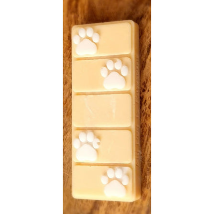 an orange wax melt bar with white paw prints