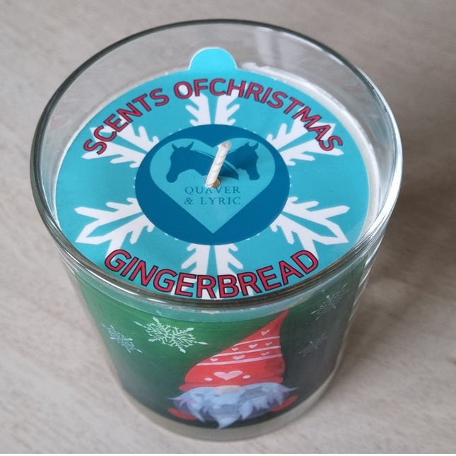 a scented candle in a glass container with a Christmas gonk design viewed from above showing the dust cover 