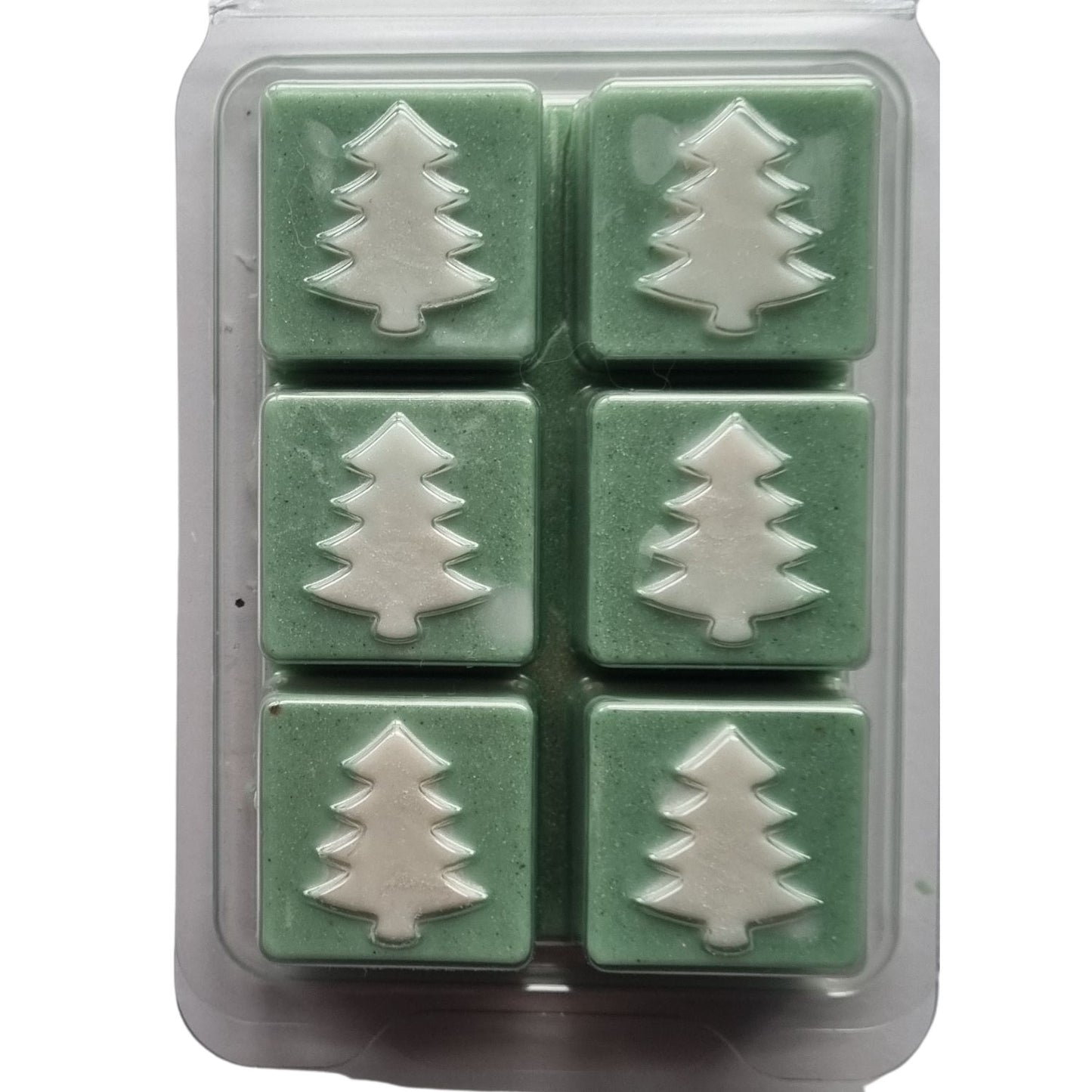 Christmas fragrance wax melts in a Christmas tree design clamshell. With white scented wax christmas trees on green scented cubes.