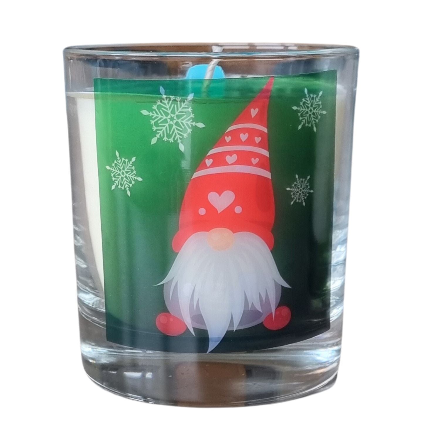 a scented candle in a glass container with a Christmas gonk design